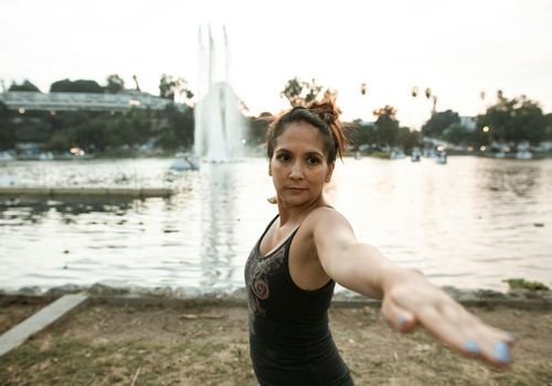 Active parent doing stretching near a park